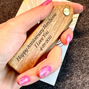 May include: A wooden engraved key chain with the text "Happy Anniversary Handsome I Love You 4-21-2011".