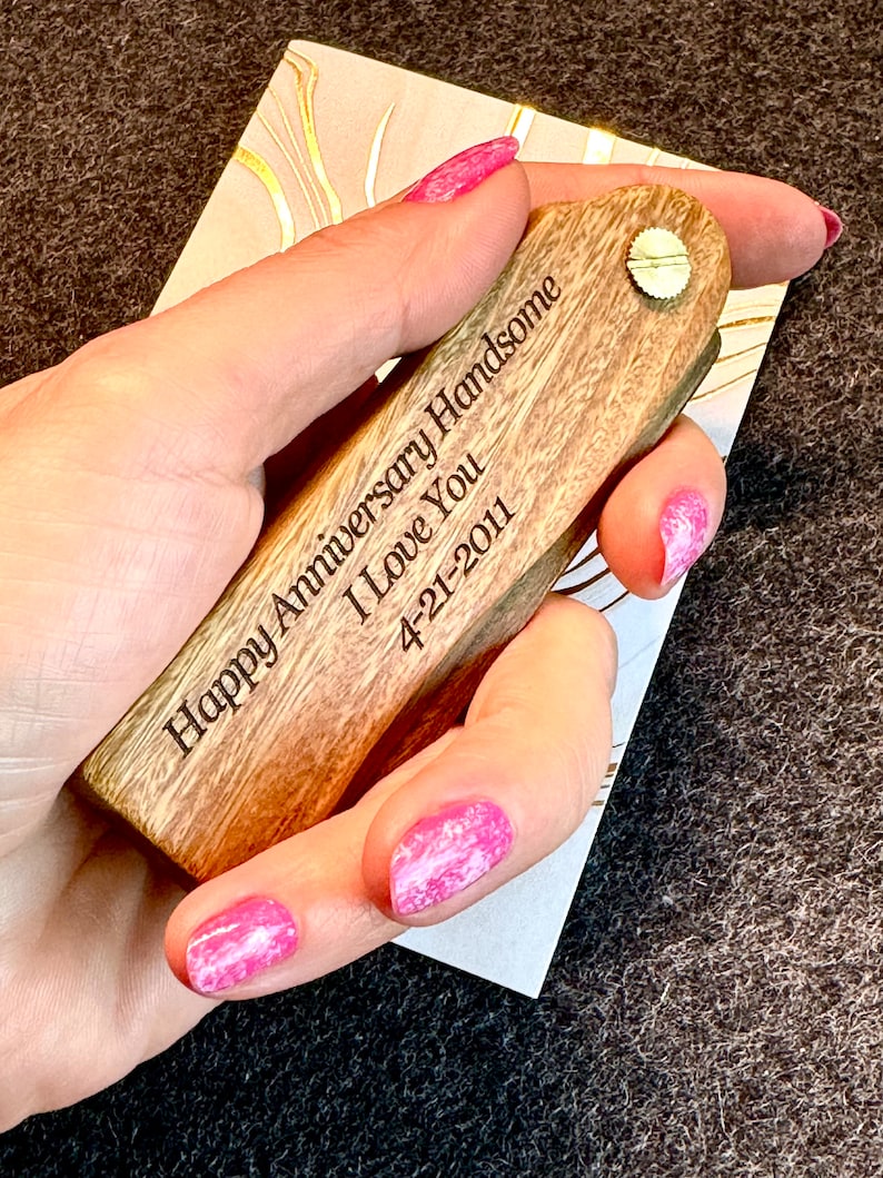 May include: A wooden engraved key chain with the text "Happy Anniversary Handsome I Love You 4-21-2011".