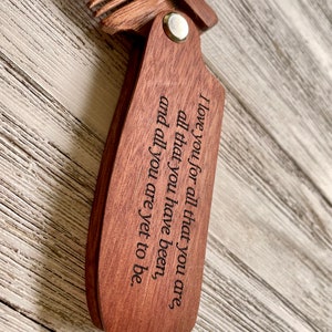 May include: A wooden comb with a message engraved on the handle: "I love you for all that you are, all that you have been, and all you are yet to be."