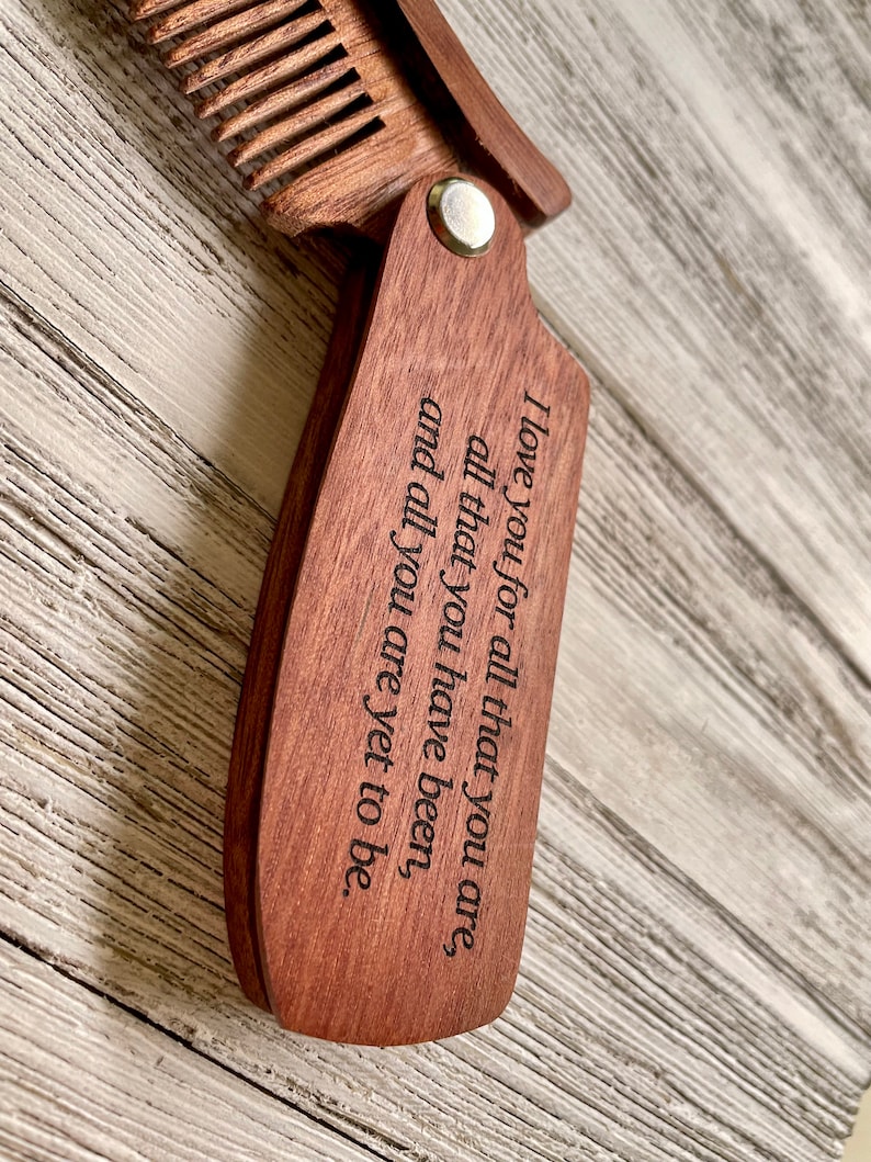 May include: A wooden comb with a message engraved on the handle: "I love you for all that you are, all that you have been, and all you are yet to be."
