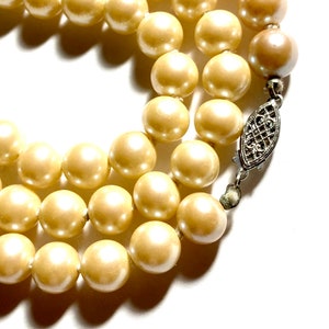 Vintage triple strand glass pearl necklace with a sterling silver box clasp. 54” long pearl necklace.