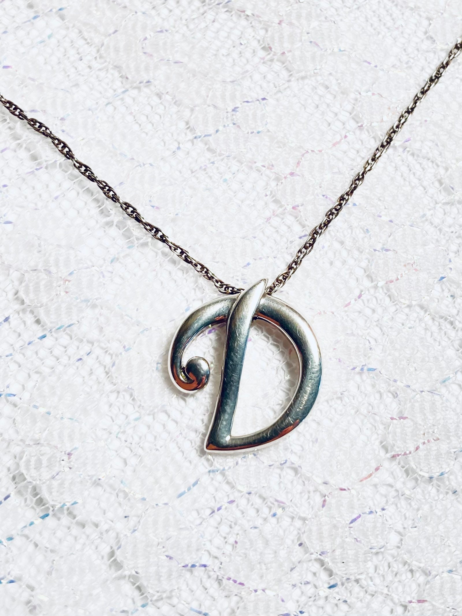 Sterling silver, letter D pendant necklace. Both marked 925. Circa