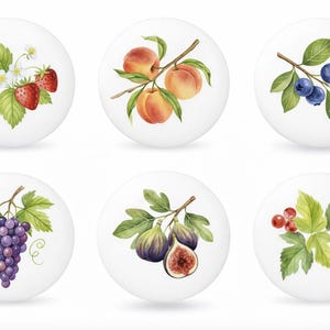 May include: Six white ceramic cabinet knobs with watercolor fruit illustrations. The designs include strawberries, peaches, blueberries, grapes, figs, and red currants. Each knob features a different fruit design with green leaves.