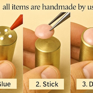 May include: A three-step process showing the creation of a handmade item. The steps are labeled: Glue, Stick, and Done. The text "all items are handmade by us" is at the top. The item is a gold cylinder with a pink top.