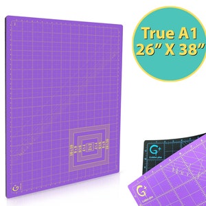 May include: A purple self-healing cutting mat with a grid pattern and measurements in inches. The mat is labeled "True A1 26" x 38"".