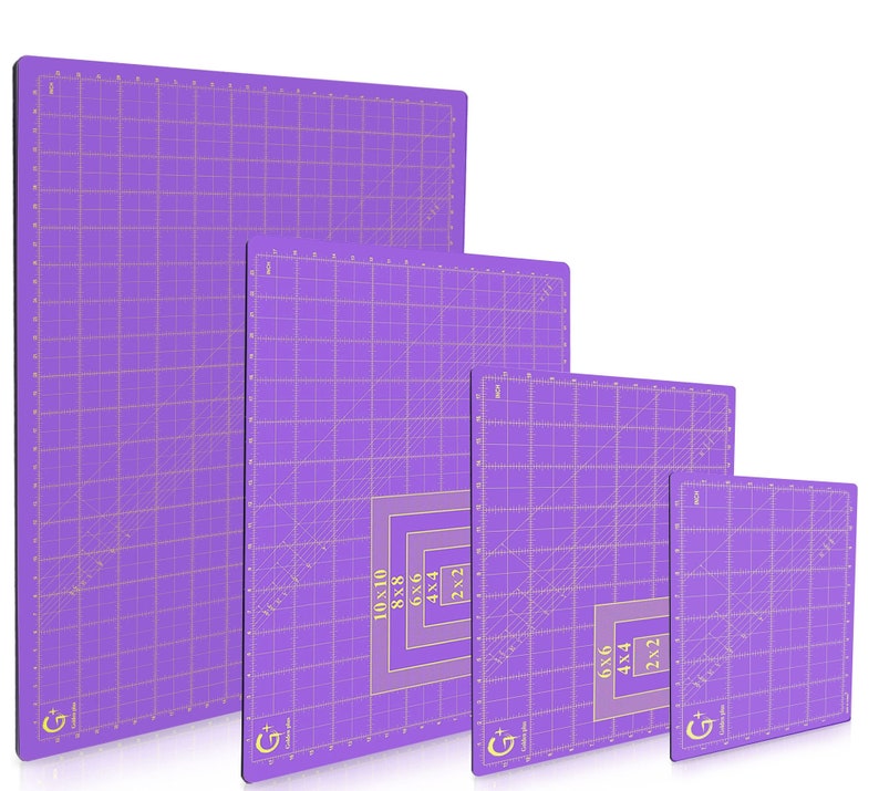 May include: Four purple self-healing cutting mats with black borders and gold grid lines. The mats are labeled with their dimensions: 10x10, 8x8, 6x6, and 4x4 inches.