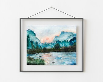 Pode incluir: Pintura de paisagem em aquarela de uma cordilheira com um rio em primeiro plano. A obra apresenta tons de azul, verde e rosa, emoldurada em uma moldura cinza escuro. A pintura retrata uma cena natural serena.