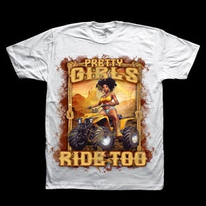 May include: White t-shirt featuring a graphic of a woman riding a yellow ATV. The graphic includes the text "PRETTY GIRLS RIDE TOO" in a decorative frame. The woman is wearing a yellow top and denim shorts.