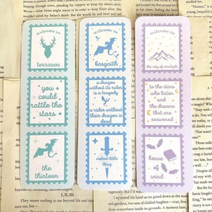 May include: Set of six fantasy-themed bookmarks with a postage stamp design. Each bookmark features a different illustration, including a stag, dragon, mountains, and text like "You could rattle the stars."