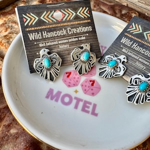 May include: A set of three ceramic mugs with a speckled, matte finish. The mugs are in shades of cream, light gray, and dark gray. Each mug has a simple, minimalist design, perfect for coffee or tea.