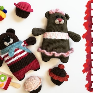 May include: Two crocheted brown teddy bears, one wearing a blue and white striped shirt and a blue scarf, the other wearing a pink tutu. There are also four crocheted cupcakes in various colors, and a fruit-shaped toy.