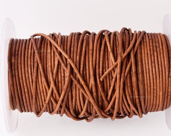 May include: A spool of brown leather cord, wound tightly and ready for crafting projects.