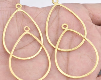 May include: Three gold-toned metal teardrop-shaped earring blanks with a loop at the top for attaching findings. The blanks are textured and have a hammered finish.