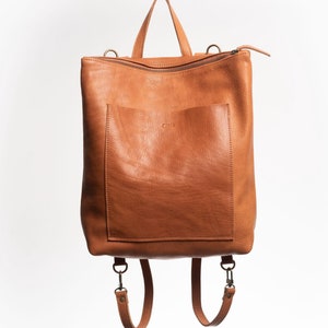Caramel full grain leather convertible backpack front view on white background, handmade vegetable tanned rucksack