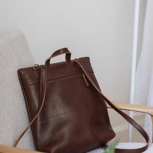 Brown leather convertible backpack front view showing straps and hardware, full grain handmade leather