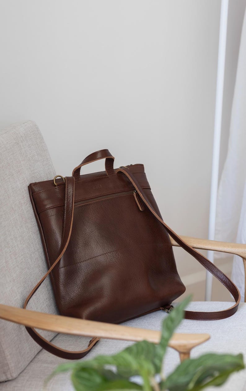 Brown leather convertible backpack front view showing straps and hardware, full grain handmade leather
