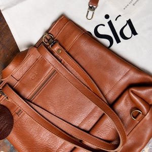 Caramel leather backpack with Casia keychain and packaging detail, handmade full grain leather gift
