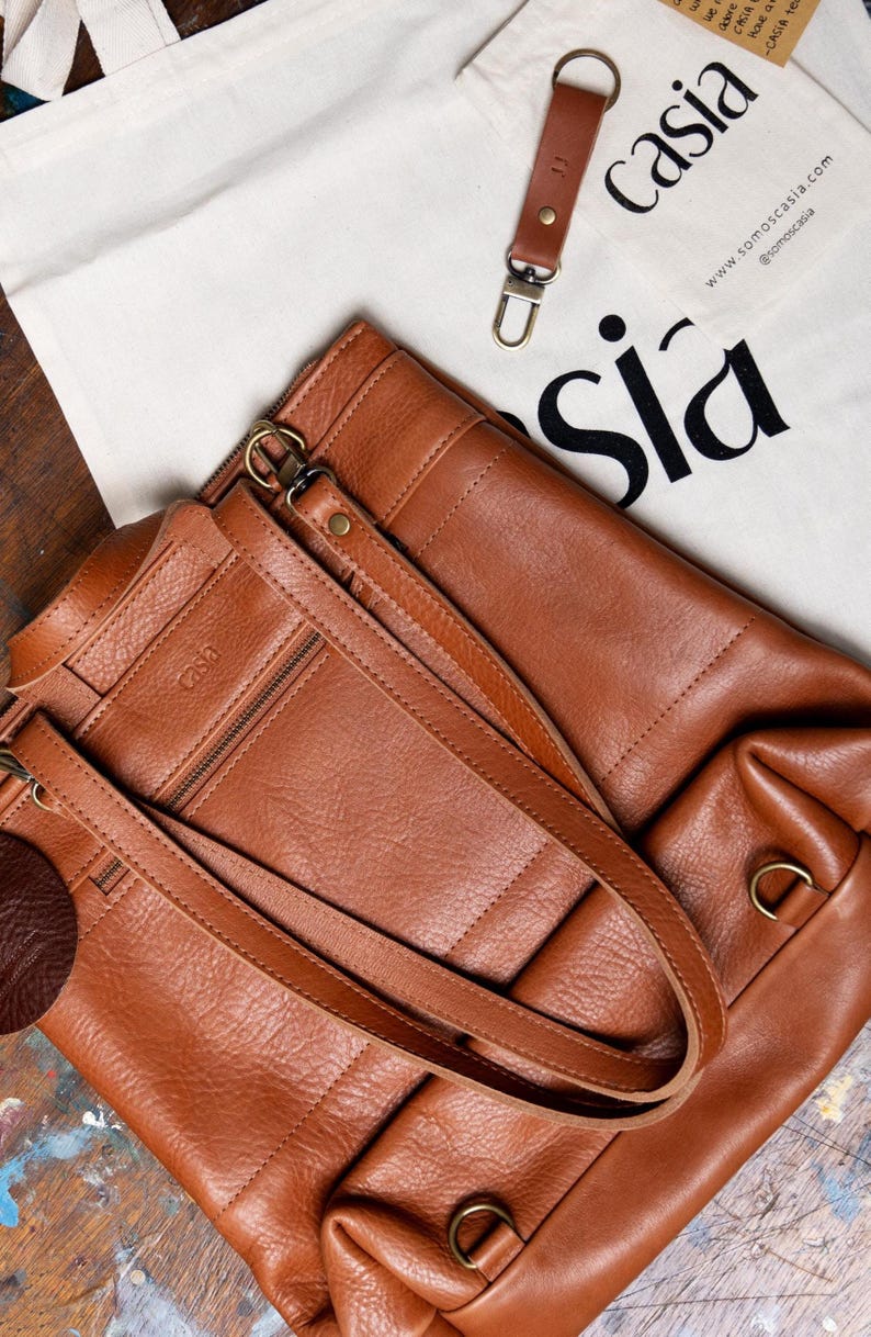 Caramel leather backpack with Casia keychain and packaging detail, handmade full grain leather gift