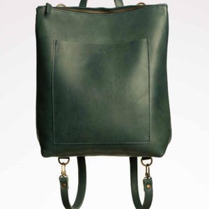 Green full grain leather convertible backpack front view on white background, handmade leather rucksack