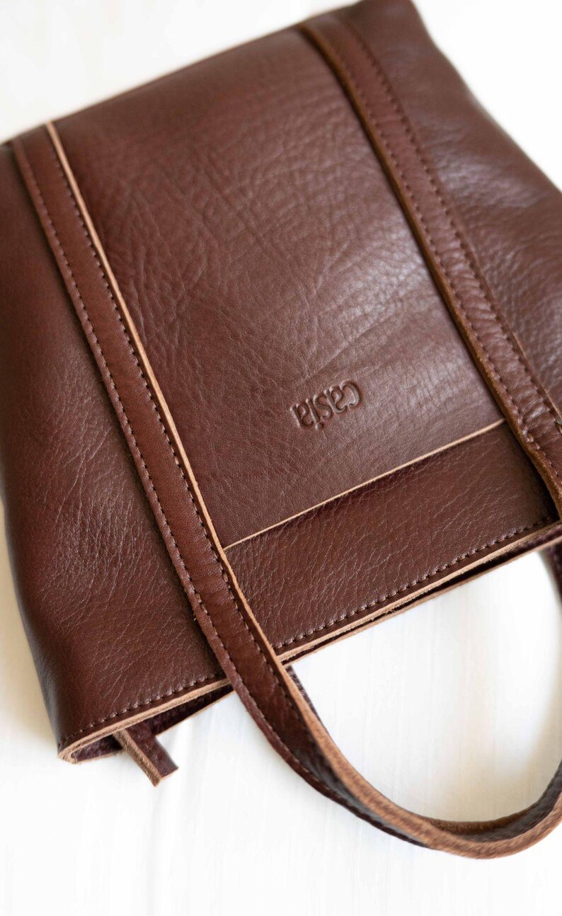 Close up of dark brown full grain leather showing vegetable tanned texture