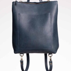 Navy blue full grain leather convertible backpack front view on white background, handmade leather rucksack