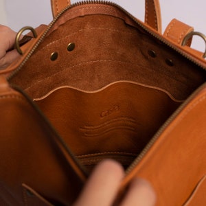 Full grain leather convertible backpack.