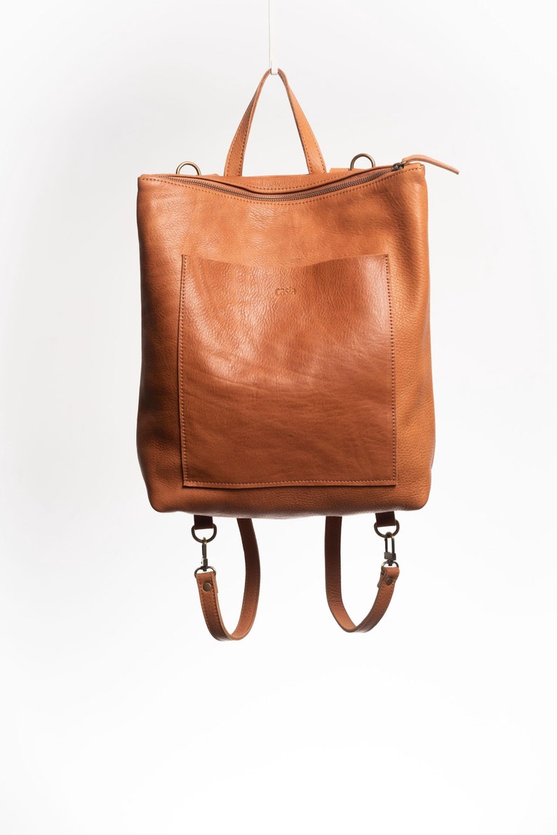 Caramel full grain leather convertible backpack front view on white background, handmade vegetable tanned rucksack