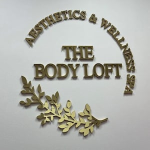 Sleek custom business logo sign with laser-cut, raised 3D letters, finished in a shiny mirror acrylic in gold, silver, or rose gold for a high-end, professional look.
