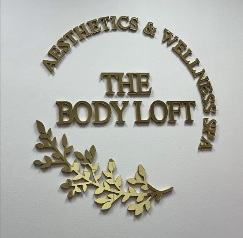 Sleek custom business logo sign with laser-cut, raised 3D letters, finished in a shiny mirror acrylic in gold, silver, or rose gold for a high-end, professional look.