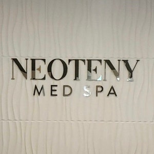 Personalized logo sign in mirror gold finish, highlighting a 3D raised design for a professional and sleek business look.