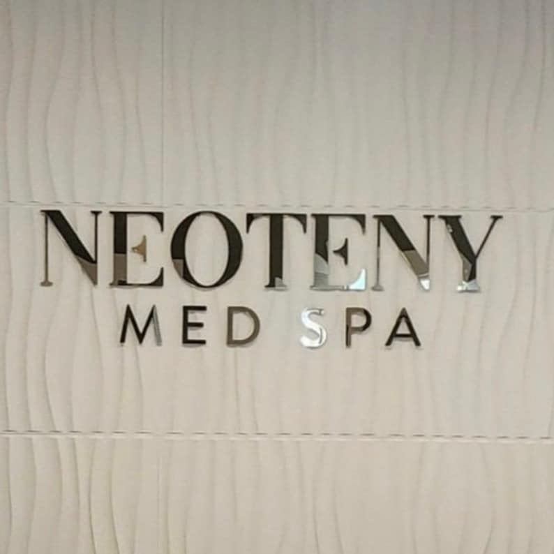 Personalized logo sign in mirror gold finish, highlighting a 3D raised design for a professional and sleek business look.