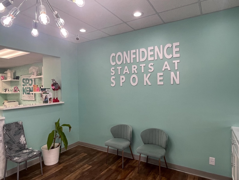 Custom laser-cut wooden business logo sign with elegant raised 3D lettering, perfect for a medspa, combining natural wood texture with a polished finish to create a welcoming and professional atmosphere.