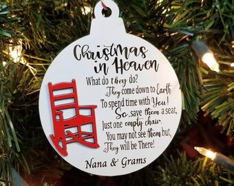 May include: White Christmas ornament with a red rocking chair and the text "Christmas in Heaven" and "What do they do? They come down to Earth To spend time with You! So, save them a seat, Just one empty chair. You may not see them but, They will be There! Nana & Grams".