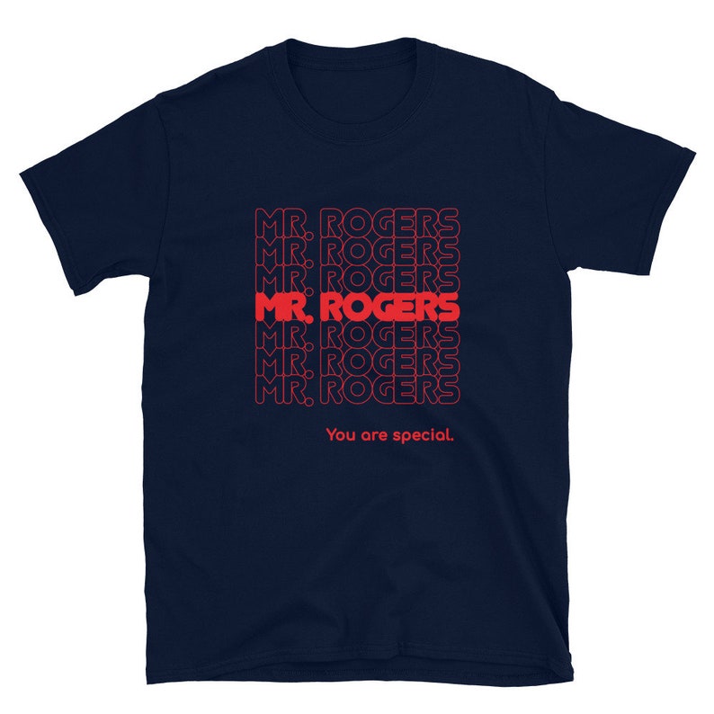 May include: Navy blue t-shirt with a repeated pattern of the text "MR. ROGERS" in red. The text "You are special." is printed below the pattern.