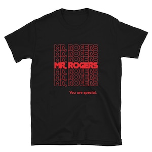 May include: Black t-shirt with a red graphic print of the phrase "MR. ROGERS" repeated multiple times. The text "You are special." is printed below the graphic.