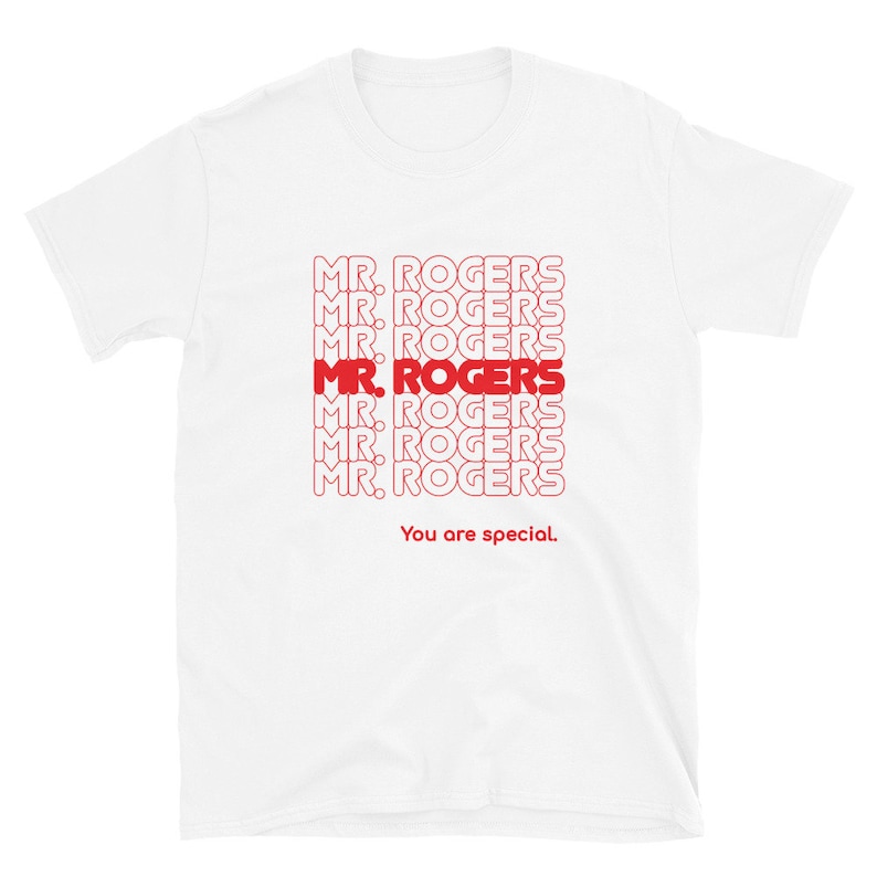 May include: White t-shirt with a red graphic print of the phrase "MR. ROGERS" repeated multiple times. The text "You are special." is printed below the graphic.