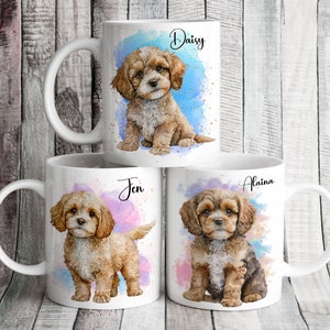 May include: Three white ceramic mugs with watercolour designs of dogs. Each mug has a different dog breed and a name on it: Daisy, Jen, and Alaina.