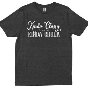 May include: A dark heather grey t-shirt with white text that reads "Kinda Classy Kinda Chola".