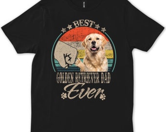 Könnte beinhalten: Schwarzes T-Shirt mit einer Retro-Grafik eines Golden Retrievers, der einen Daumen hoch zeigt. Die Grafik lautet "Best Golden Retriever Dad Ever" mit Sternen und Pfotenabdrücken.