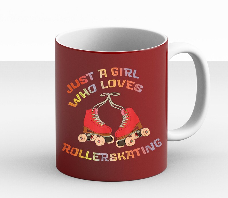 May include: Red coffee mug with a white interior and handle. The mug features a graphic of roller skates with the text "Just a girl who loves rollerskating" in rainbow colors.