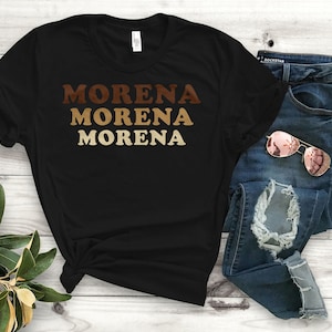 May include: Black t-shirt with the word "MORENA" repeated three times in brown, tan, and gold lettering.