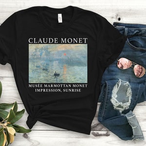 May include: Black t-shirt with a white print of Claude Monet's Impression, Sunrise painting. The text below the painting reads "Mus&eacute;e Marmottan Monet Impression, Sunrise".