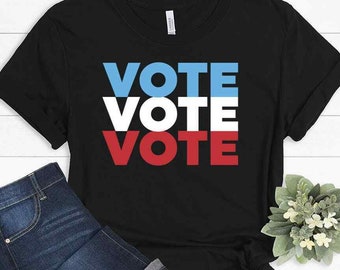 May include: Black t-shirt with the word "VOTE" repeated three times in red, white, and blue.
