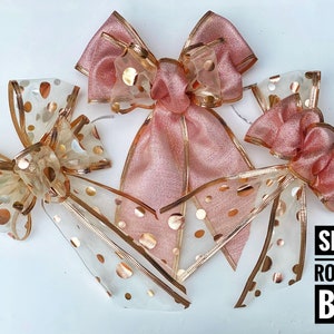 May include: Set of six rose gold bows with polka dots. The bows are made of sheer fabric with gold glitter dots and have a rose gold satin ribbon.
