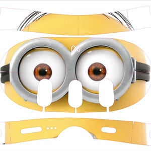 May include: A yellow Minion-themed craft project with large brown eyes, silver goggles, and white teeth. The design includes cut-out shapes and QR codes with the text "Scan for application tutorial video!" and "SCAN ME".