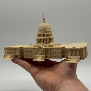 May include: A beige 3D printed model of the United States Capitol Building.