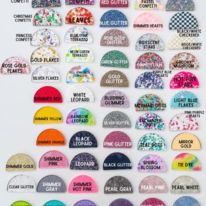 May include: A selection of colourful, semi-circular glitter and confetti designs. Each design is labelled with a unique name, such as "Red Glitter," "Mermaid Dots," and "Black Leopard." Suitable for crafting and embellishments.