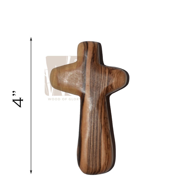 May include: A 4-inch wooden cross made of olive wood with a dark brown and light brown striped pattern.