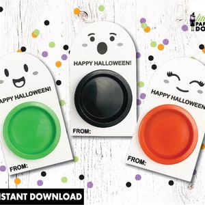 May include: Three printable Halloween treat bags featuring ghost faces with different expressions. Each bag has a circle in the center for a treat and the text "Happy Halloween!"  The bags are white with black and gray details.