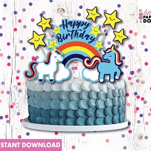 May include: A blue and white unicorn cake topper with a rainbow and stars. The cake topper says "Happy Birthday".